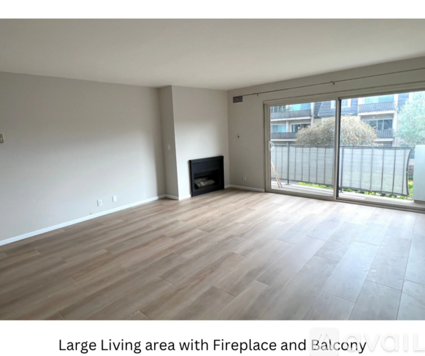 A large living area with a fireplace and balcony.