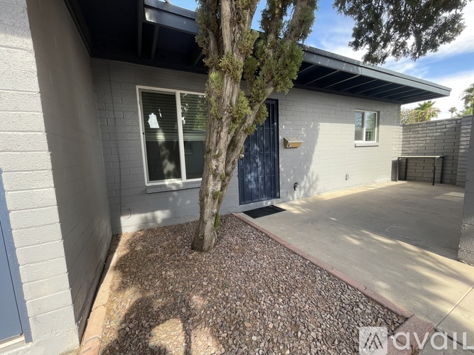 A house with a tree in front of it is for sale.