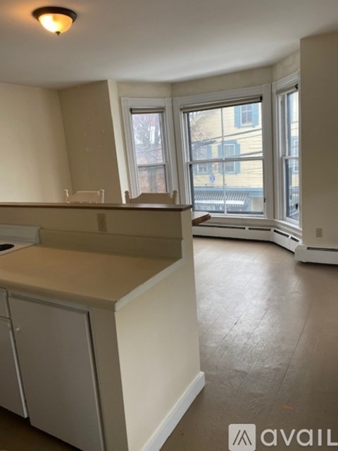 A kitchen with white cabinets and a countertop.