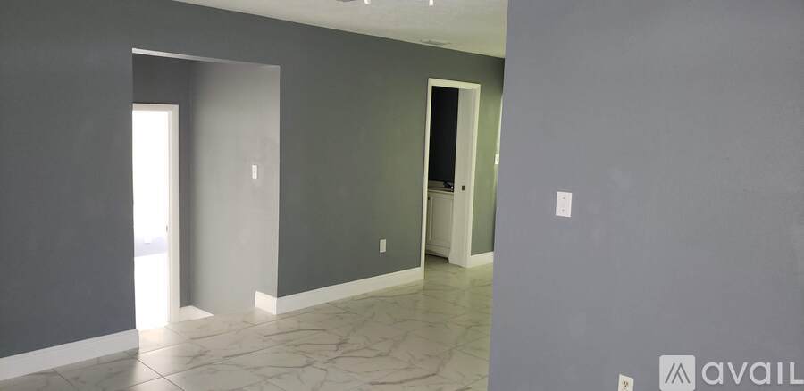 A hallway with a sign that says "available" on the wall.