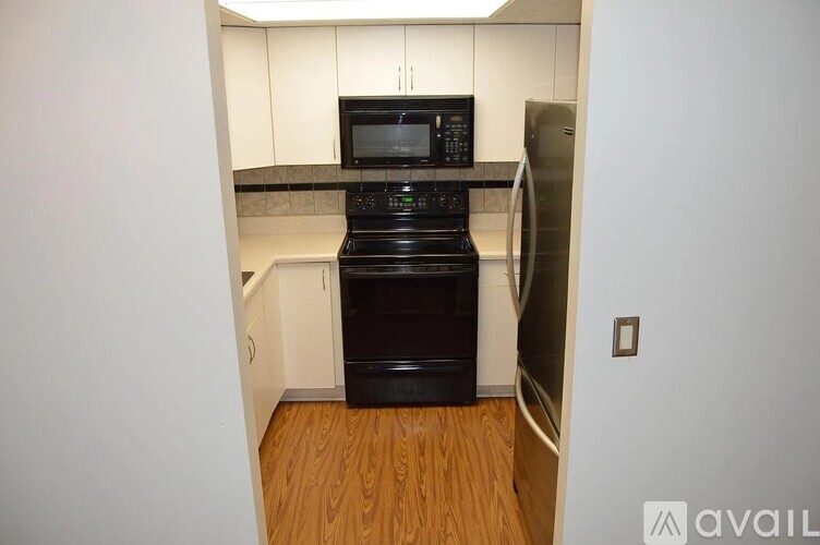 A kitchen with a black oven and a black microwave.