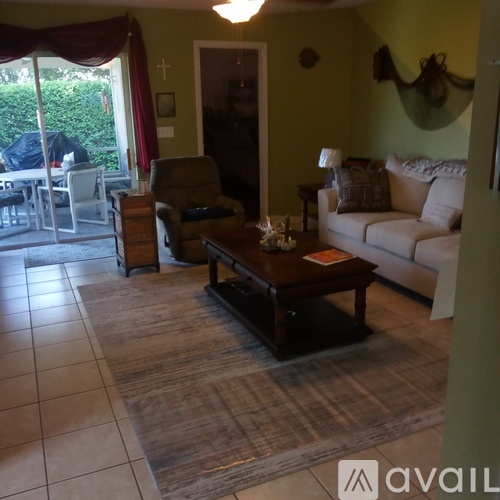 A living room with a couch, chair, and coffee table.