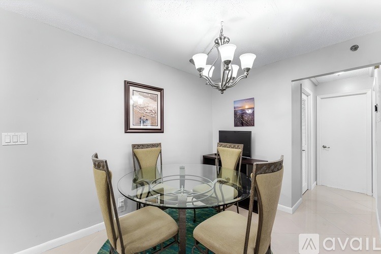 A dining room with a glass table and chairs.