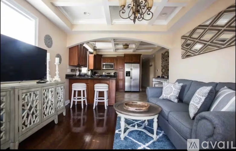 A living room with a grey couch and a coffee table.