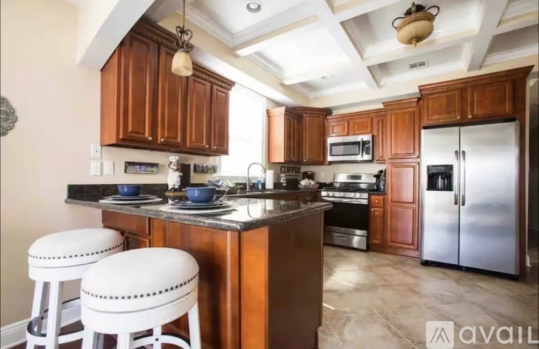 A kitchen with wooden cabinets and a black countertop.