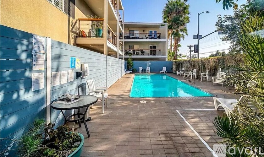 A pool area with a table and chairs is shown.