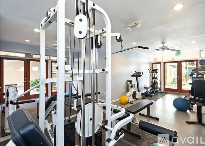 A well-equipped home gym with a variety of exercise machines.