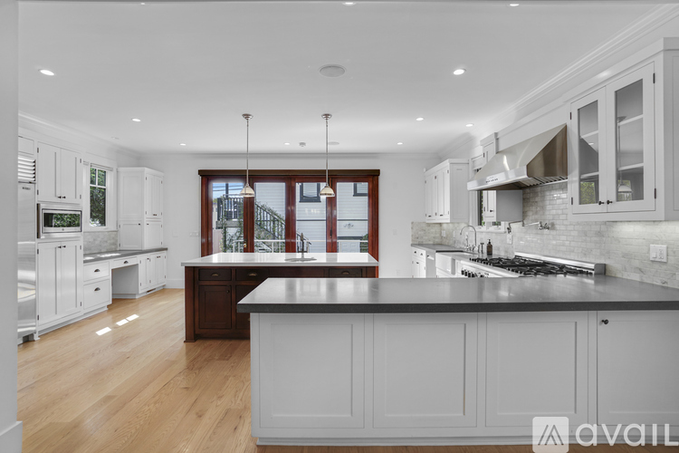 A modern kitchen with a large island in the center.