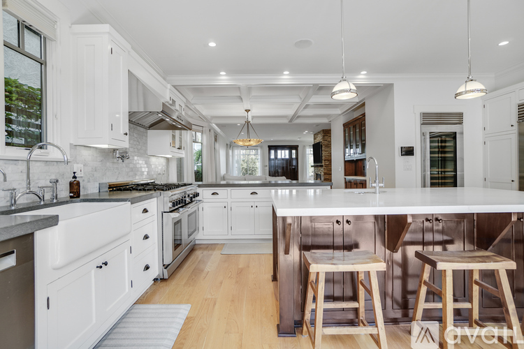 A modern kitchen with white cabinets and a large island.