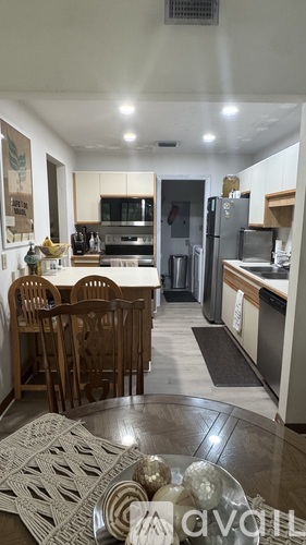A kitchen with a table and chairs in the middle of the room.