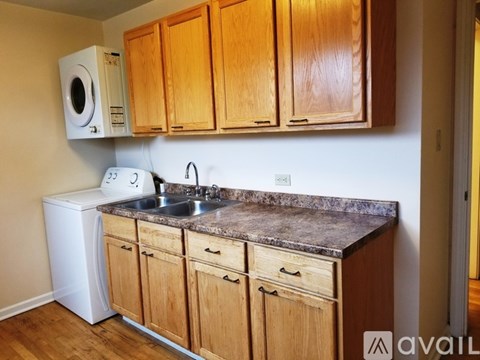 A kitchen with wooden cabinets and a granite countertop.