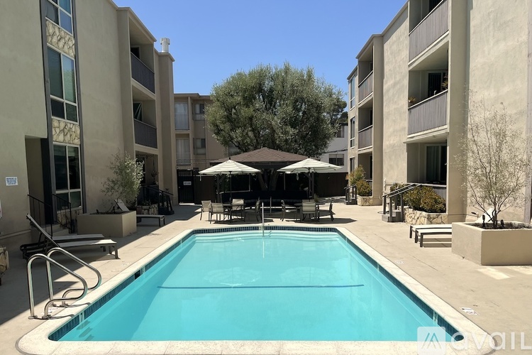 A swimming pool surrounded by apartment buildings.
