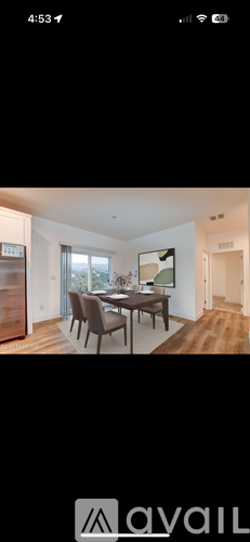 A modern dining room with a wooden table and chairs.