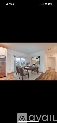 A modern dining room with a wooden table and chairs.