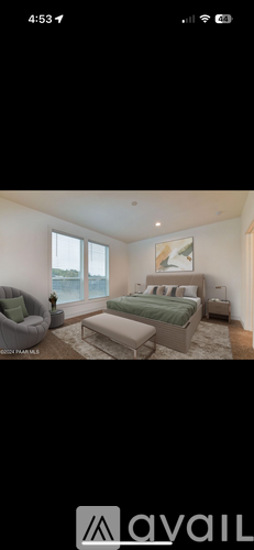 A bedroom with a bed, a chair, and a window.