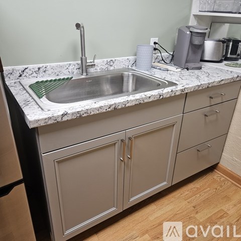 A kitchen with a sink and a counter.