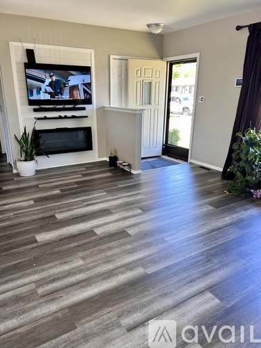 A living room with a television and a fireplace.