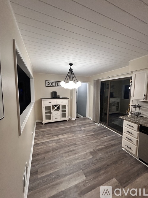 A kitchen area with a sign that says "COFFEE" on the wall.