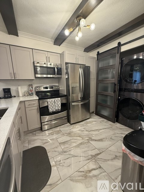 A kitchen with a black fridge and stove.