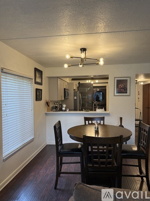 A dining room with a table and chairs.