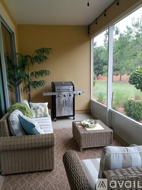 A living room with a sofa, chair, and a table with a bowl on it.