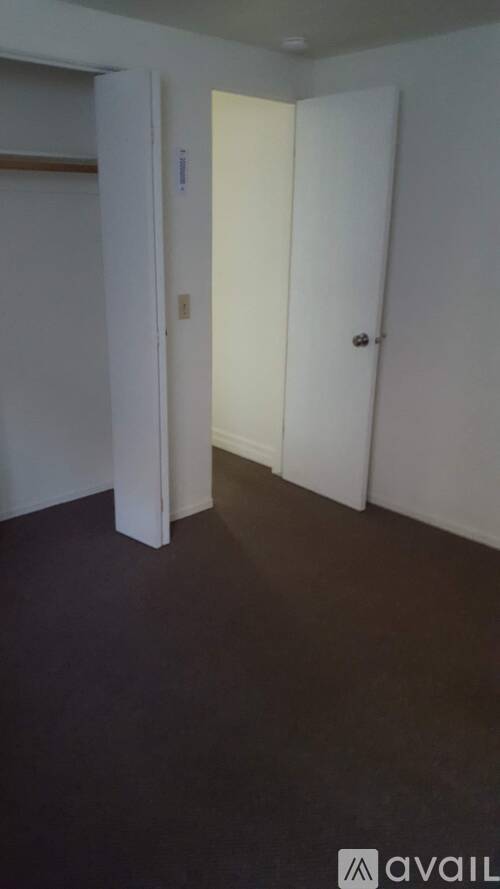A room with a white door and a white wall.