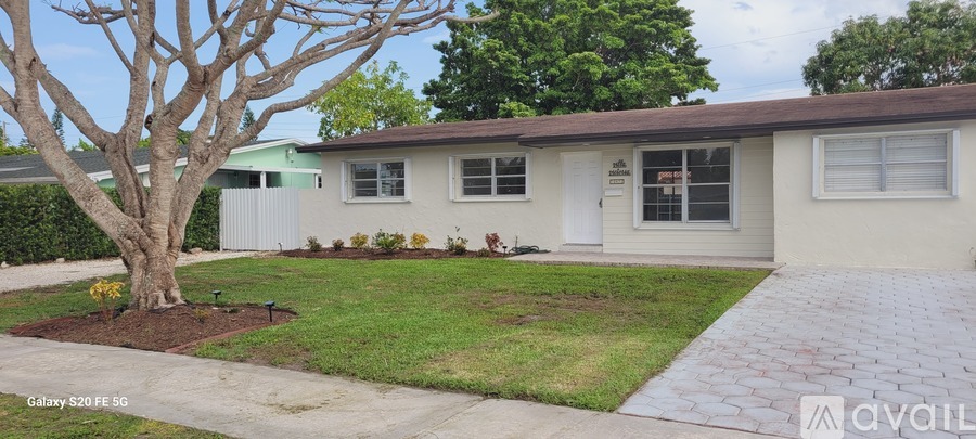 A house with a tree in front of it.