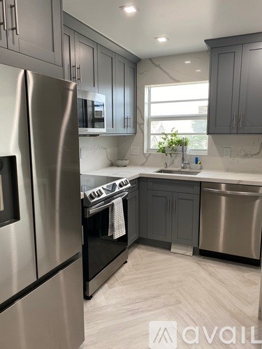 A kitchen with a stainless steel refrigerator and a dishwasher.
