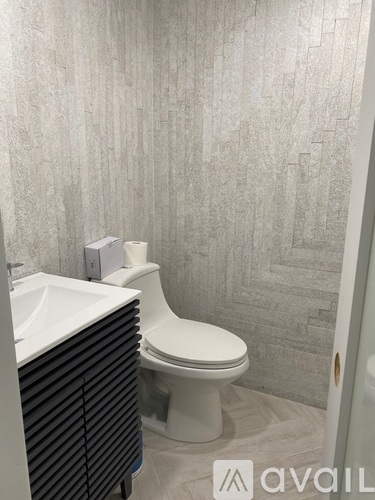 A bathroom with a toilet and a sink.