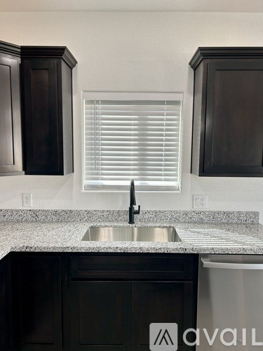 A kitchen with a sink and cabinets.