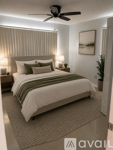 A bedroom with a large bed and a ceiling fan.