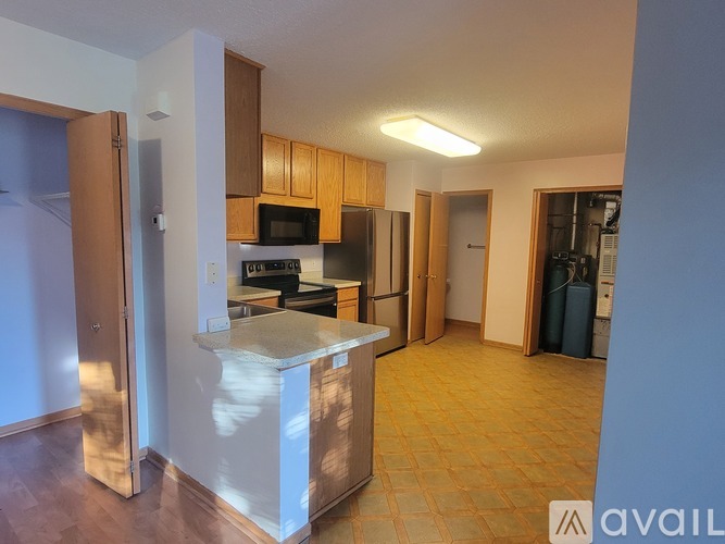 A kitchen with a white island in the middle of the room.