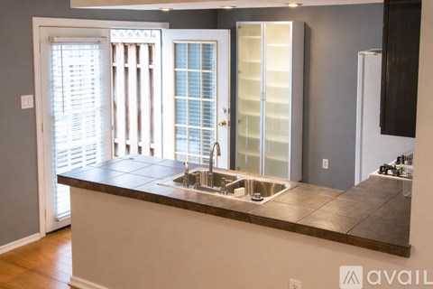 A kitchen with a sink and a window.