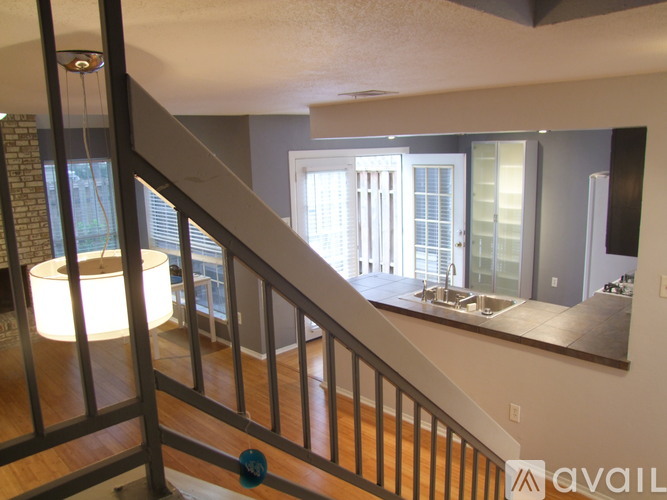 A staircase with a light on the side and a mirror on the wall.
