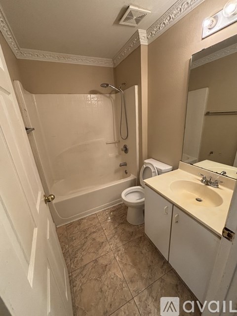 A bathroom with a toilet, sink, and shower.