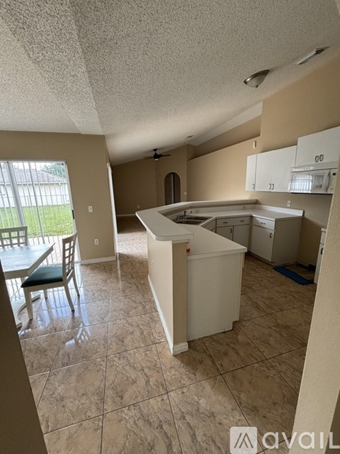 A kitchen with tile flooring and a dining table with chairs.