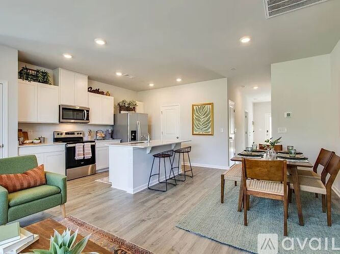 A kitchen with a dining table and chairs.