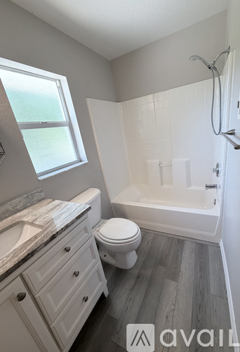 A bathroom with a toilet, sink, and bathtub.