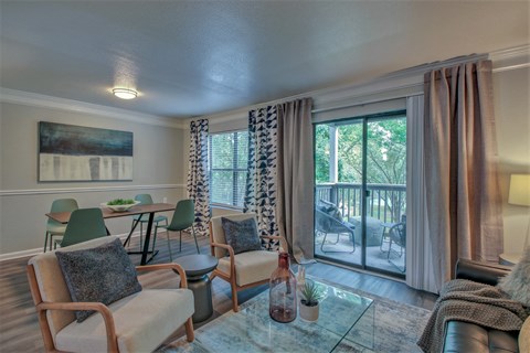 A living room with a glass table and chairs.