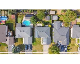 A bird's eye view of a residential area with houses and a swimming pool.