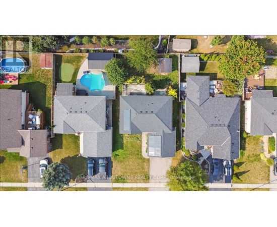A bird's eye view of a residential area with houses and a swimming pool.