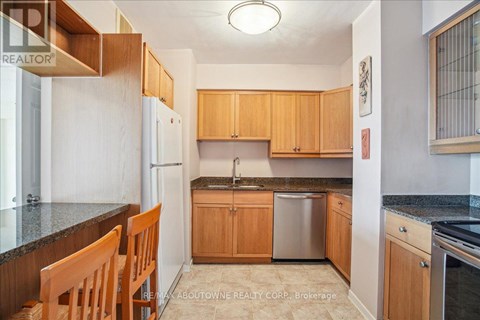 A kitchen with wooden cabinets and granite countertops.