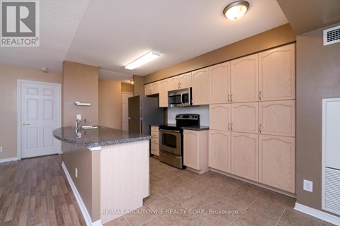 A kitchen with wooden cabinets and a granite countertop.