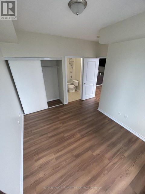 A room with wood flooring and white walls.