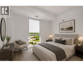 A bedroom with a large bed and a view of the outdoors through a window.
