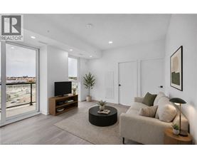 A living room with a couch, a television, and a plant.