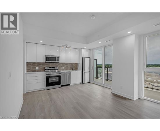 A modern kitchen with a stainless steel oven and microwave.
