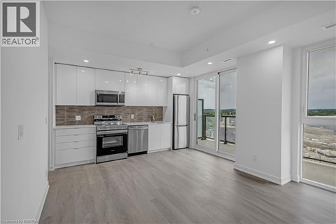 A modern kitchen with a stainless steel oven and microwave.