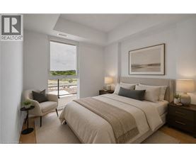 A bedroom with a large bed, a chair, and a painting on the wall.