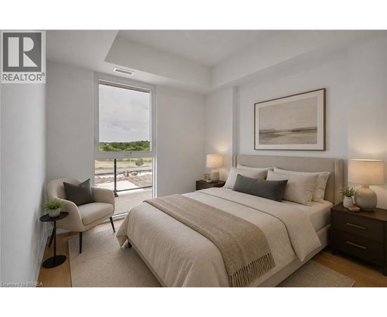 A bedroom with a large bed, a chair, and a painting on the wall.